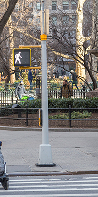 Pole at a NYC intersection with traffic and pedestrian signals