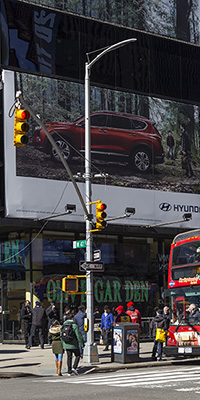 Pole at a NYC intersection with traffic and pedestrian signals